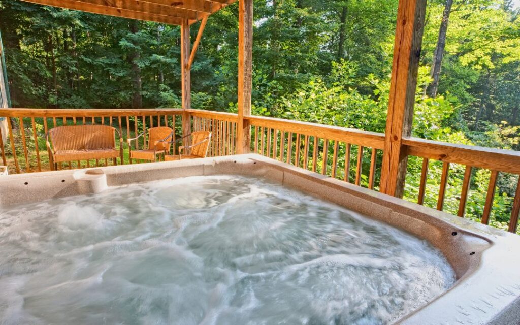 Spa on deck of a home in a wooded area