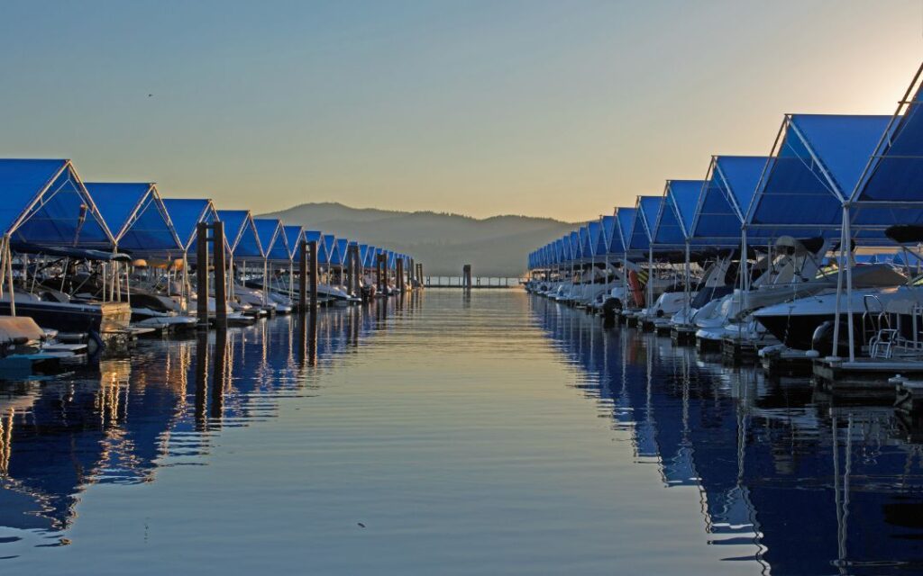 Two rows of boat lifts at a lake marina