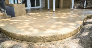 Finished stamped and colored concrete patio in a northwest Iowa backyard.