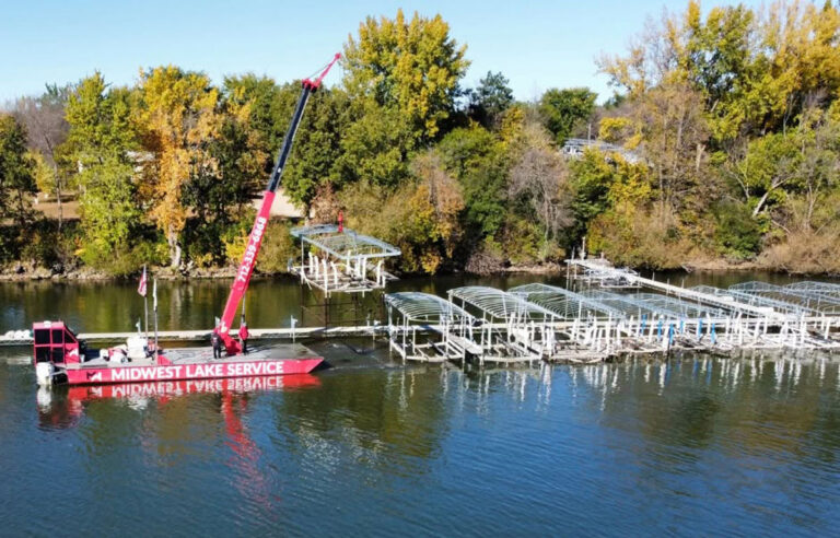 Midwest Lake Service crew removing a boat hoist during fall dock and hoist removal in the Iowa Great Lakes
